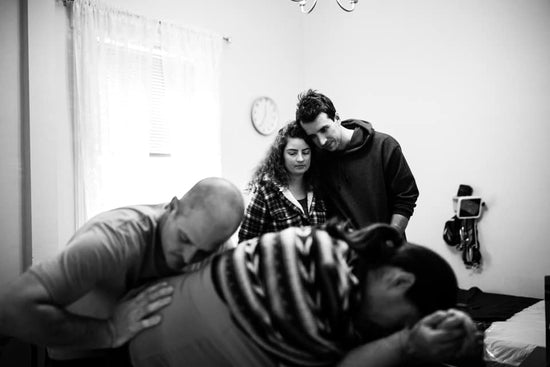 Surrogate in labor supported by birth team, with intended parents present—an emotional chapter for modern baby memory books.